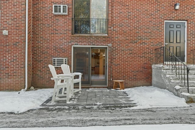 view of snow covered property entrance