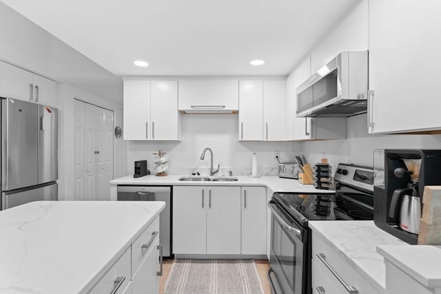 2A Brewer St, Boston, MA 02130 - kitchen with appliances with stainless steel finishes, a sink, white cabinets, light stone counters, and recessed lighting