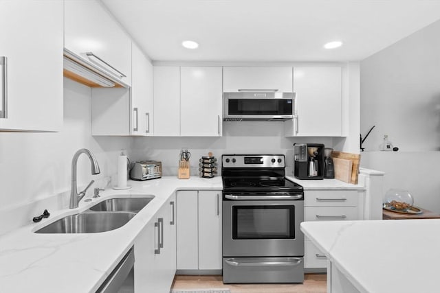 2A Brewer St, Boston, MA 02130 - kitchen with appliances with stainless steel finishes, a sink, white cabinets, light stone countertops, and recessed lighting