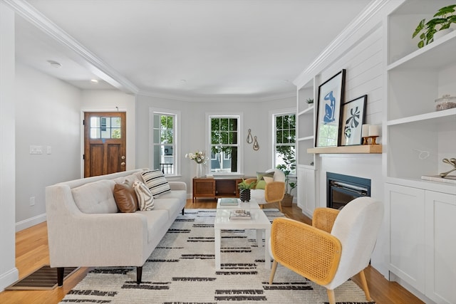 living room with light wood-type flooring and ornamental molding