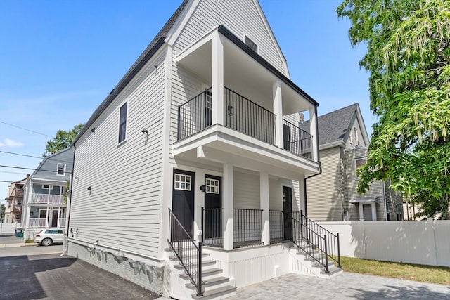 view of front of home with a balcony and covered porch