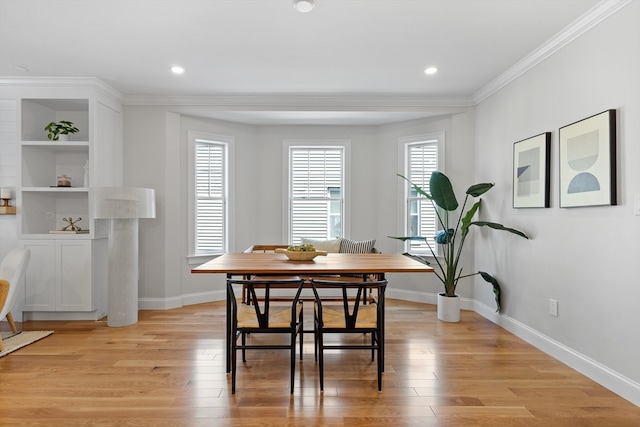 dining area with breakfast area, light hardwood / wood-style floors, and crown molding