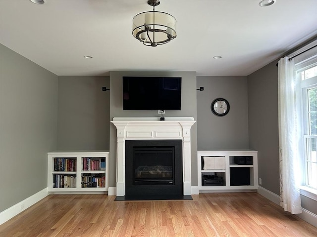61 School St Unit B, Natick, MA 01760 - unfurnished living room with wood finished floors, a fireplace with flush hearth, and recessed lighting