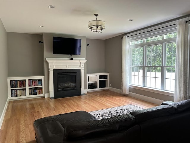 61 School St Unit B, Natick, MA 01760 - living area featuring light wood-type flooring, a fireplace with flush hearth, and recessed lighting