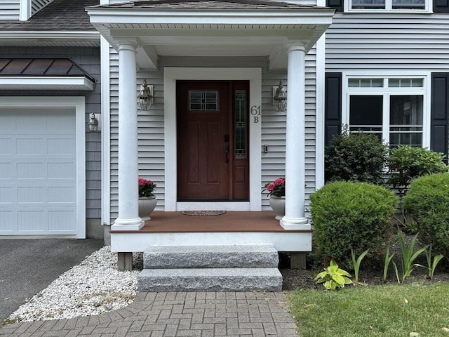 61 School St Unit B, Natick, MA 01760 - doorway to property with an attached garage and a shingled roof