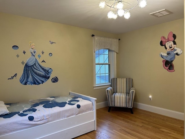61 School St Unit B, Natick, MA 01760 - bedroom with wood finished floors and a chandelier