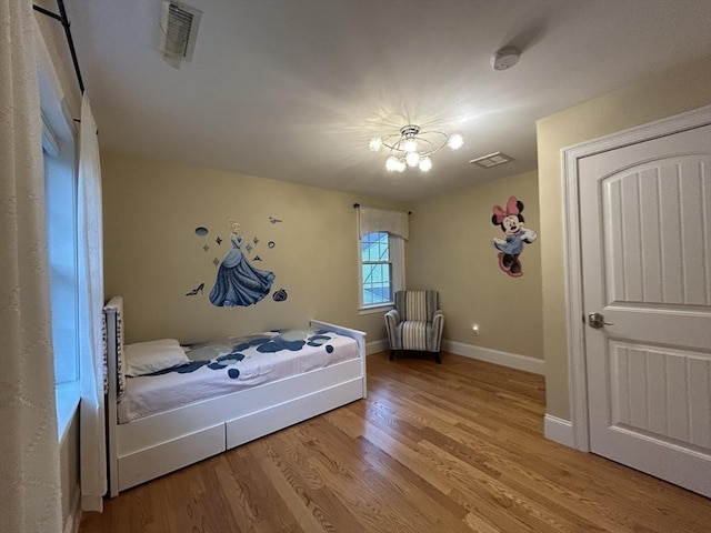 61 School St Unit B, Natick, MA 01760 - bedroom featuring wood finished floors and a chandelier