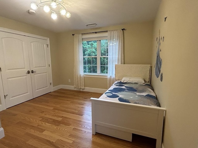 61 School St Unit B, Natick, MA 01760 - bedroom with a chandelier, light wood finished floors, and a closet