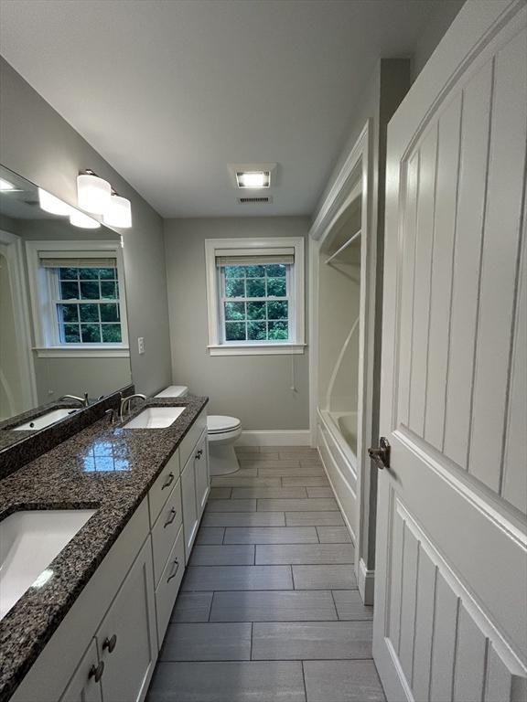 61 School St Unit B, Natick, MA 01760 - bathroom with double vanity, wood finish floors, and  shower combination