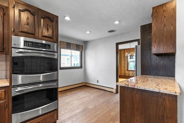 kitchen featuring light wood-style flooring, double oven, visible vents, tasteful backsplash, and recessed lighting