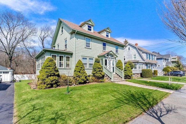 view of front of house with fence and a front yard