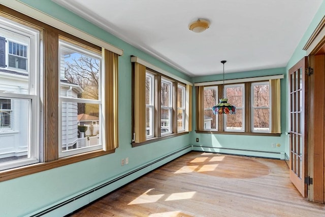 interior space with light wood-style flooring and a baseboard radiator