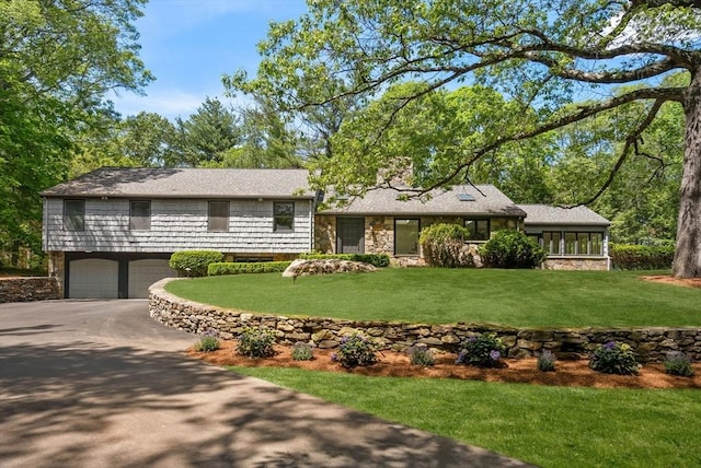 169 Hickory Rd, Weston, MA 02493 - tri-level home featuring driveway, a garage, a front yard, and stone siding