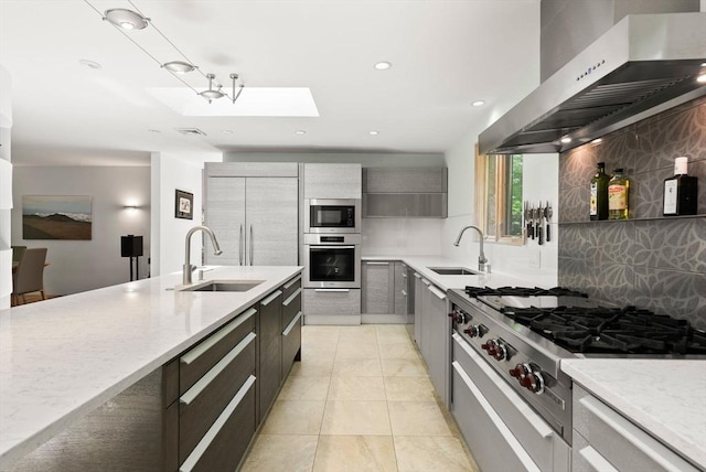 169 Hickory Rd, Weston, MA 02493 - kitchen featuring appliances with stainless steel finishes, wall chimney exhaust hood, a sink, decorative backsplash, and recessed lighting