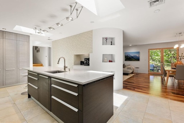 169 Hickory Rd, Weston, MA 02493 - kitchen with a sink, a skylight, light tile patterned flooring, and open floor plan