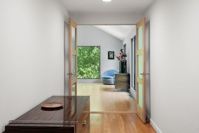 169 Hickory Rd, Weston, MA 02493 - hall featuring light wood-style floors, lofted ceiling, and french doors