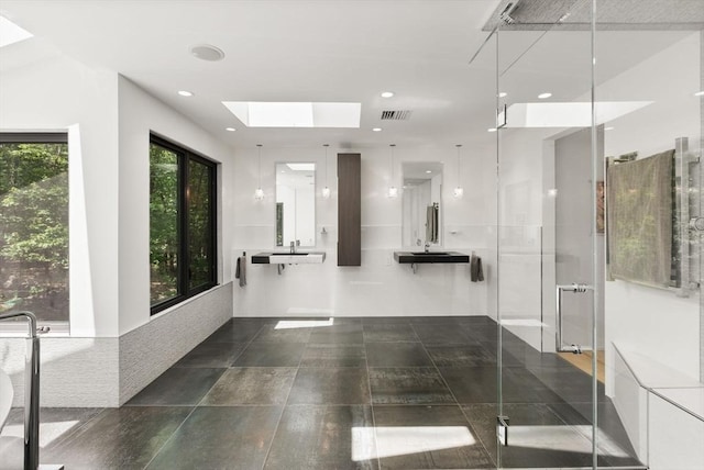 169 Hickory Rd, Weston, MA 02493 - bathroom featuring a skylight, a stall shower, recessed lighting, and a sink