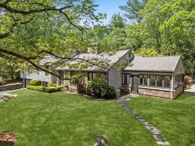 169 Hickory Rd, Weston, MA 02493 - back of property with stone siding, a shingled roof, a yard, and a chimney