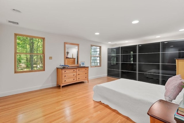 169 Hickory Rd, Weston, MA 02493 - bedroom with multiple windows, light wood-style floors, baseboards, and recessed lighting