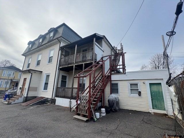 rear view of property with a balcony