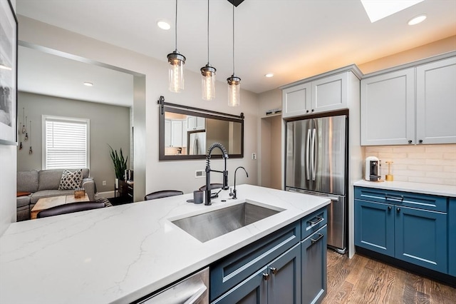 101 Draper St Unit 3, Boston, MA 02122 - kitchen with freestanding refrigerator, a sink, pendant lighting, blue cabinets, and dark wood-style floors