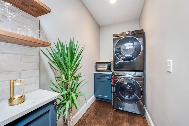 101 Draper St Unit 3, Boston, MA 02122 - washroom with estacked washer and dryer, baseboards, dark wood finished floors, and cabinet space