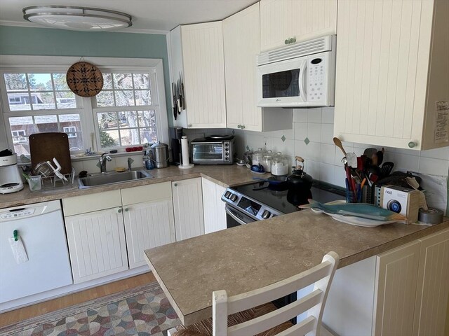 25 Day Rd, Wellfleet, MA 02667 - kitchen with white cabinets, white appliances, a sink, and tasteful backsplash