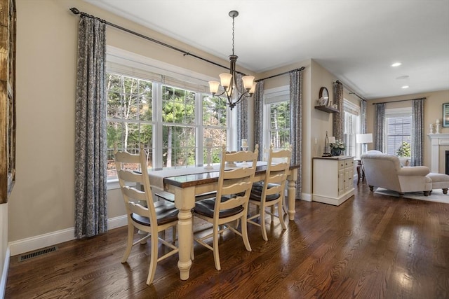 dining space with visible vents, baseboards, an inviting chandelier, recessed lighting, and dark wood-type flooring