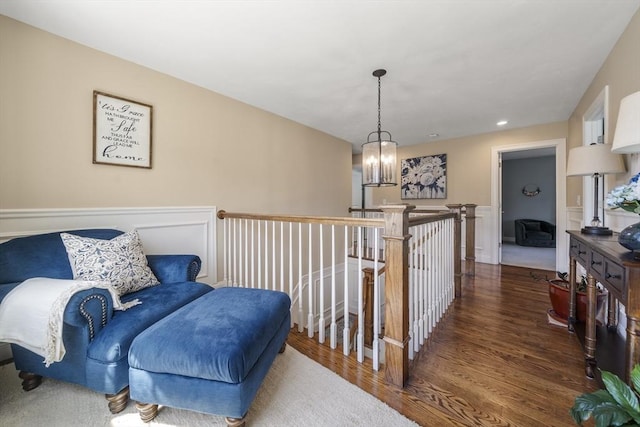 living area with wood finished floors and a chandelier