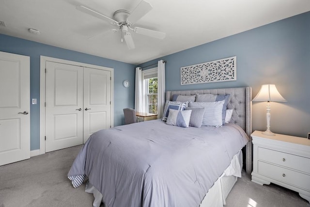 bedroom featuring carpet, ceiling fan, baseboards, and a closet