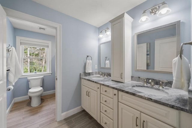 full bathroom with a sink, baseboards, wood finished floors, and visible vents