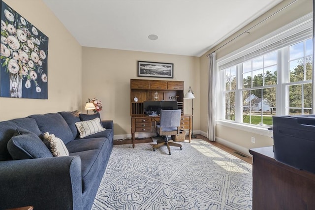 office area with visible vents, wood finished floors, and baseboards