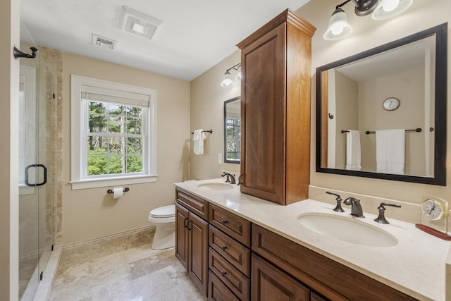 bathroom featuring visible vents, a shower stall, toilet, and a sink