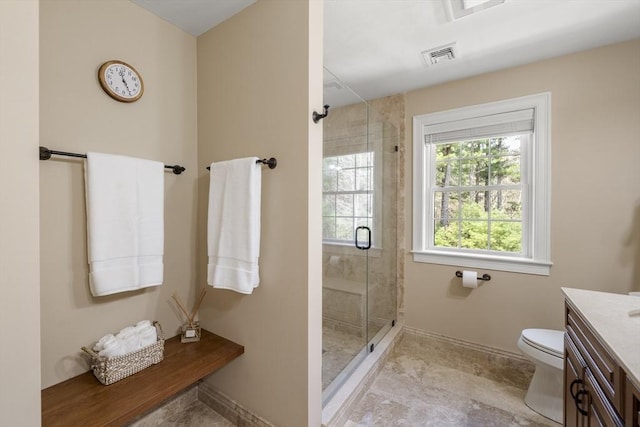 bathroom featuring toilet, visible vents, vanity, and a shower stall