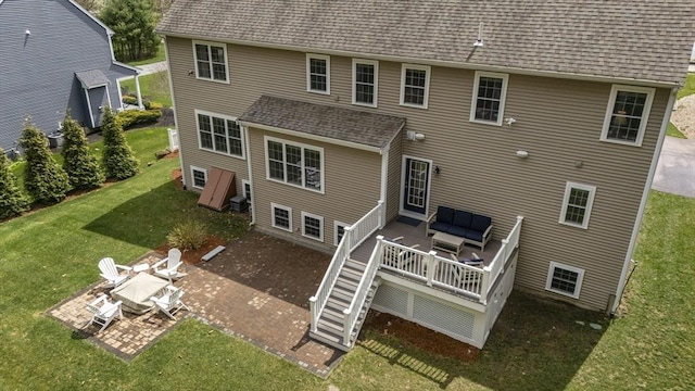 back of property featuring a patio, a lawn, roof with shingles, an outdoor hangout area, and a deck