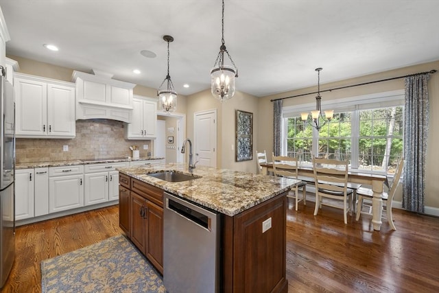 kitchen featuring a sink, a chandelier, stainless steel appliances, white cabinetry, and dark wood finished floors