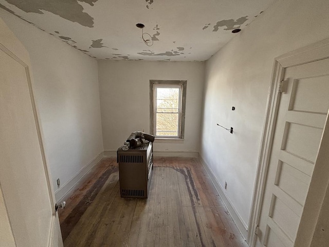 miscellaneous room featuring dark wood-type flooring and baseboards