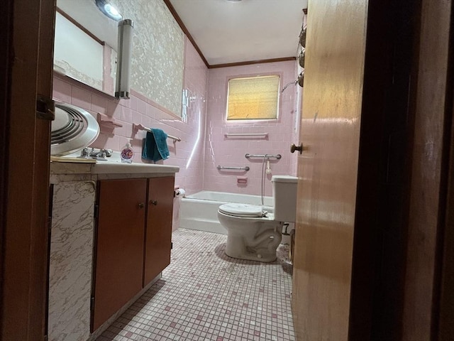 bathroom with toilet, vanity, bathing tub / shower combination, ornamental molding, and tile patterned floors