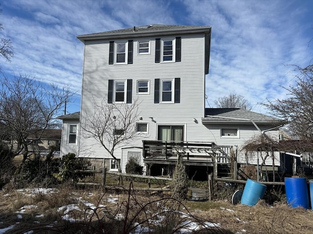 back of house with a wooden deck