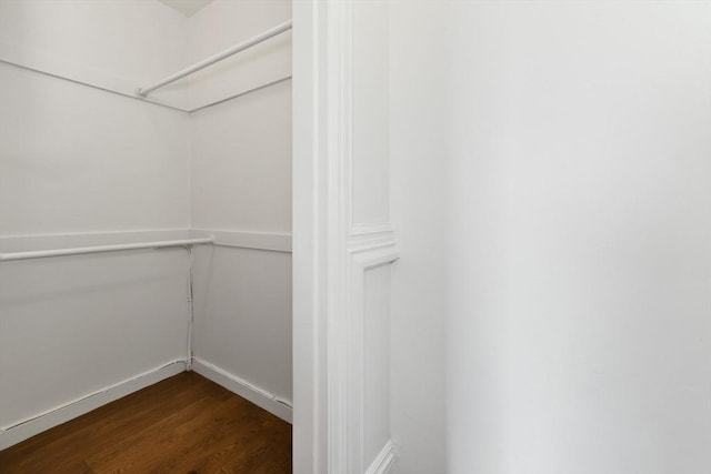 walk in closet featuring dark wood-type flooring