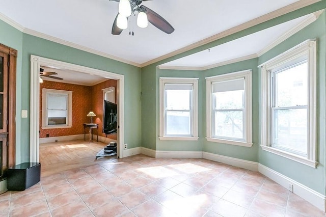 empty room featuring baseboards, light tile patterned floors, a ceiling fan, and crown molding