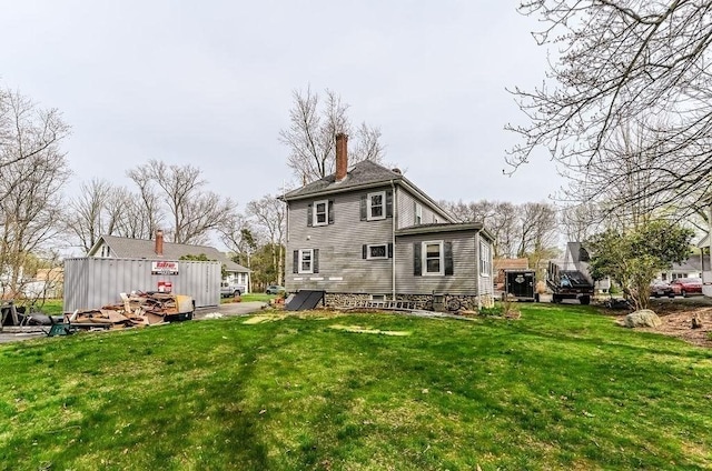 back of property featuring a lawn and a chimney