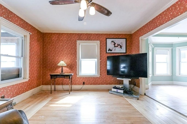 living room featuring a healthy amount of sunlight, hardwood / wood-style flooring, and wallpapered walls