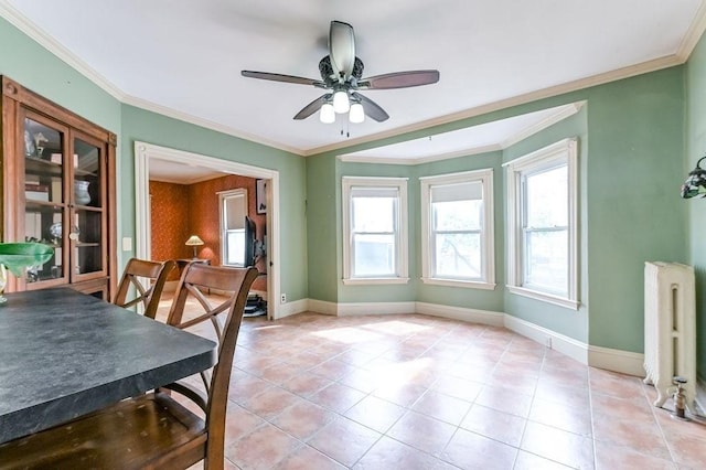 dining room featuring radiator, crown molding, a ceiling fan, and baseboards