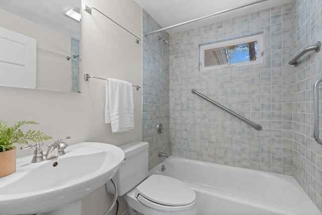 full bathroom featuring washtub / shower combination, toilet, and a sink