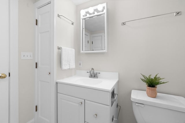 half bathroom featuring toilet and vanity