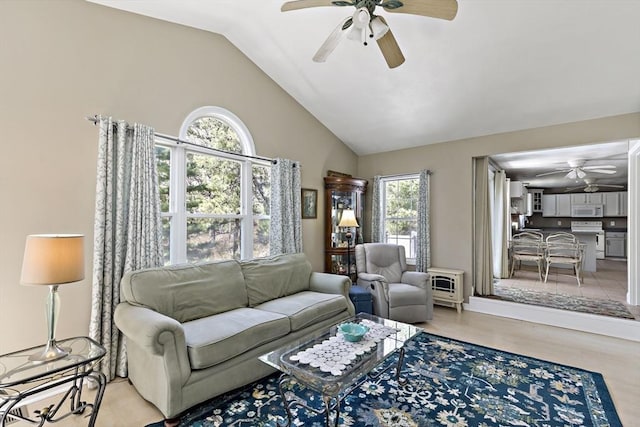 living area with high vaulted ceiling and ceiling fan