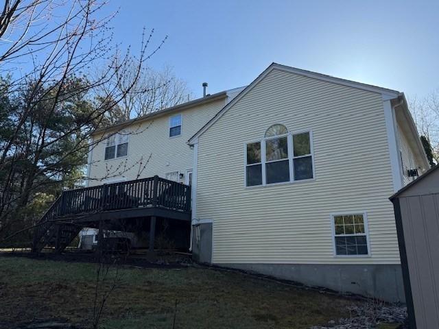 back of property with stairs and a deck
