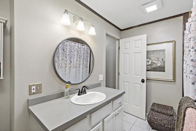bathroom with vanity, ornamental molding, and tile patterned floors