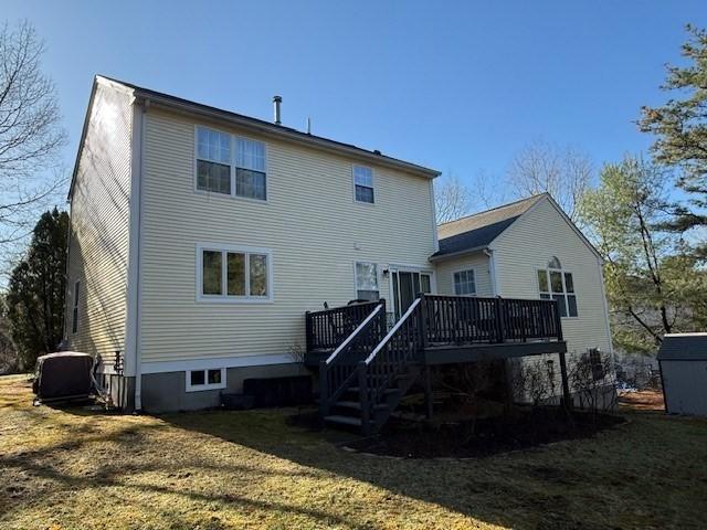 back of house featuring a yard, a deck, and stairway